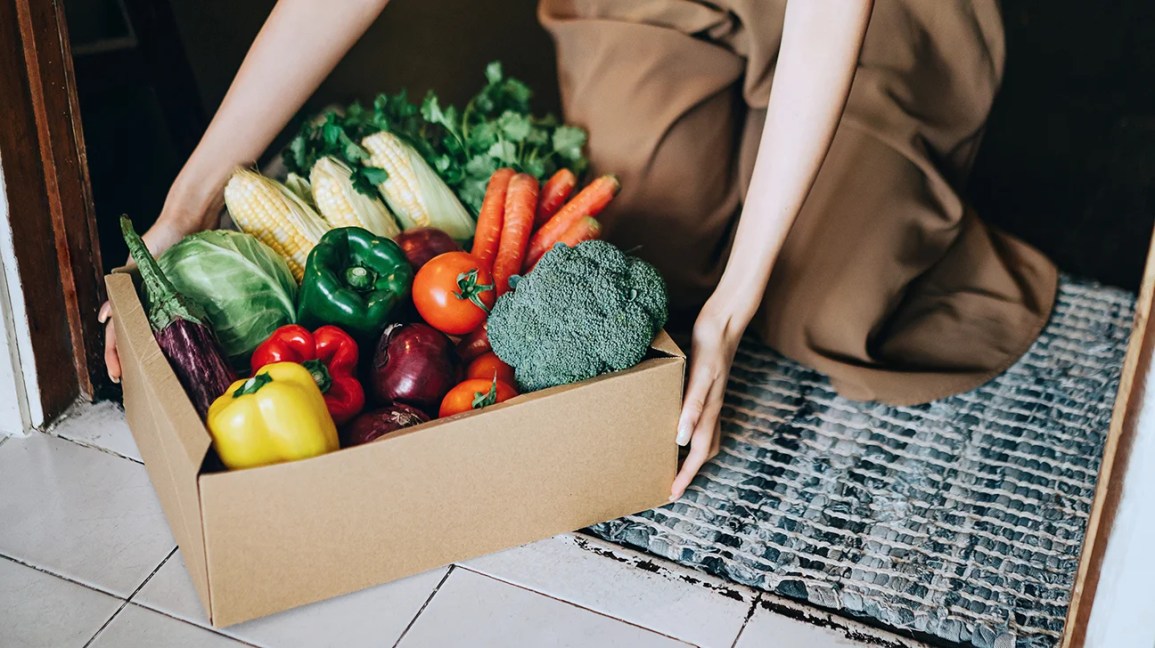 Carrying in a delivery box with fresh produce