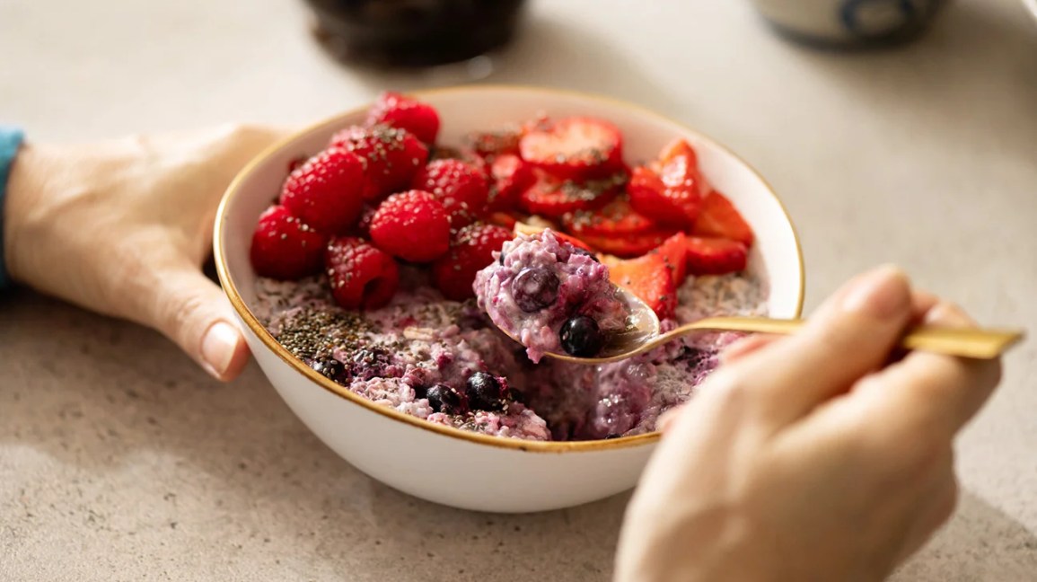 spoonful of oatmeal with strawberries, blueberries, and raspberries