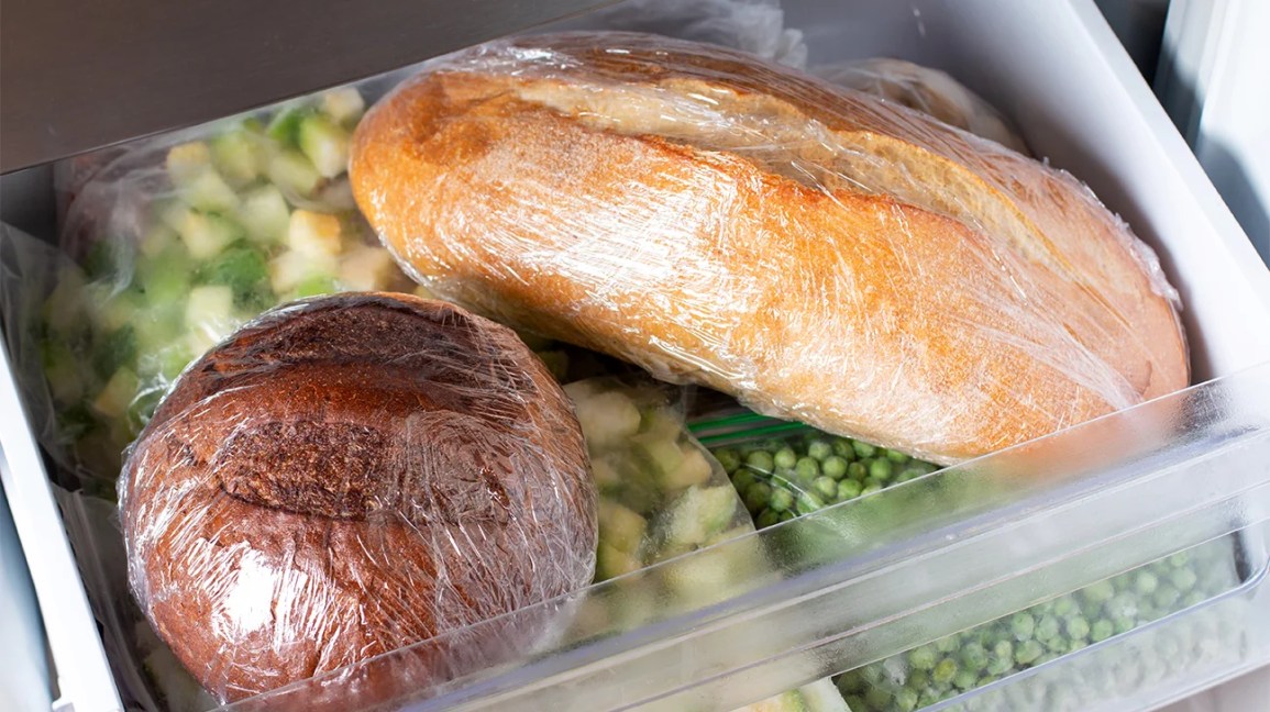 two loaves of bread wrapped up in the freezer